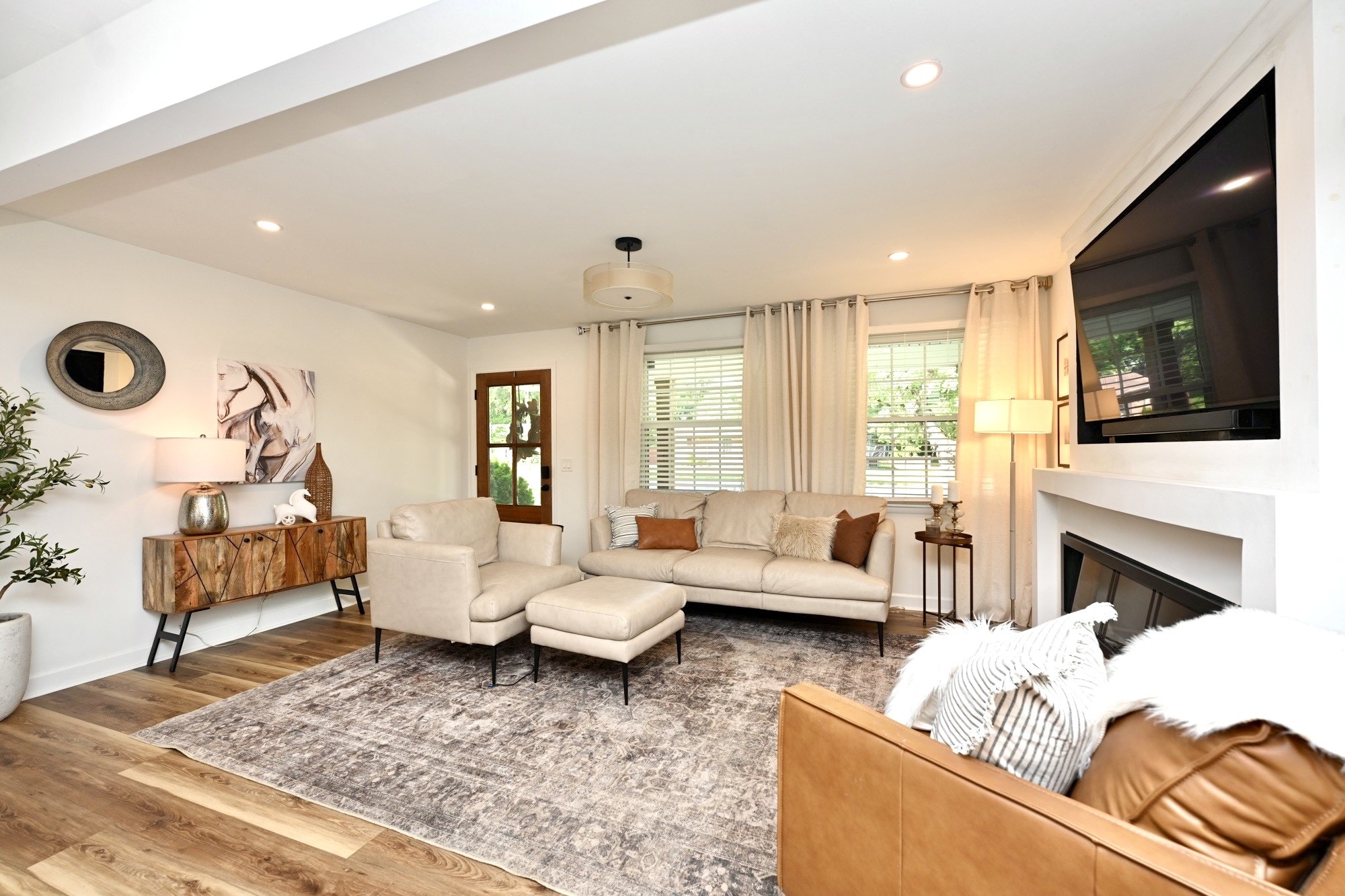 Staged living room — warm tones, styled furniture, natural light